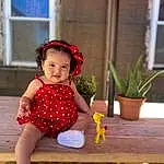 Skin, Plant, Leg, Green, Baby & Toddler Clothing, Sleeve, Table, Smile, Happy, Flowerpot, Leisure, Toddler, Fun, Houseplant, Recreation, Baby, Wood, Sandal, Hat, Grass, Person