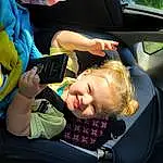 Smile, Vehicle, Seat Belt, Car, Vroom Vroom, Automotive Design, Steering Wheel, Car Seat Cover, Car Seat, Vehicle Door, Toddler, Head Restraint, Automotive Exterior, Fun, Auto Part, Personal Luxury Car, Family Car, Child, Travel, Windshield, Person, Joy