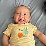Nose, Cheek, Skin, Smile, Chin, Hand, Outerwear, Arm, Facial Expression, Mouth, Neck, Baby & Toddler Clothing, Textile, Sleeve, Standing, Baby, Happy, Finger, Person