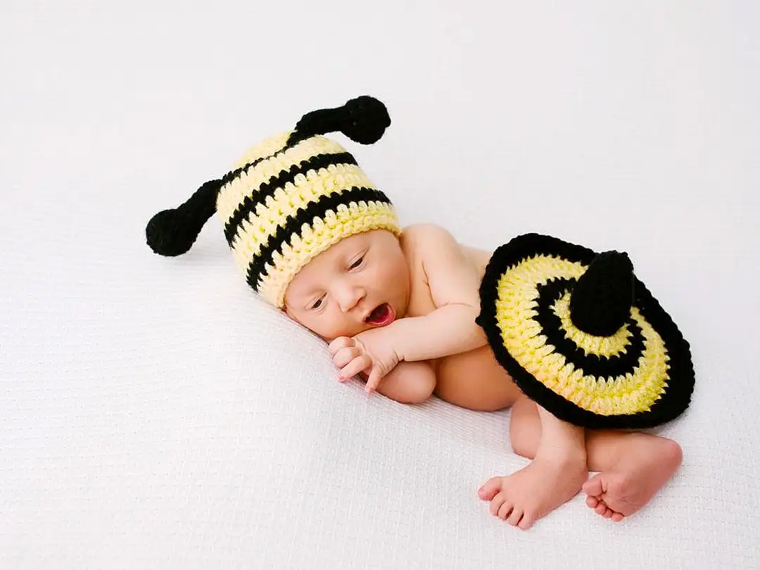 Baby & Toddler Clothing, Sleeve, Gesture, Baby, Happy, Finger, Cap, Headgear, Font, Insect, Eyelash, Baby Sleeping, Linens, Costume Hat, Child, Baby Products, Headpiece, Fashion Accessory, Toy, Knit Cap, Person, Headwear