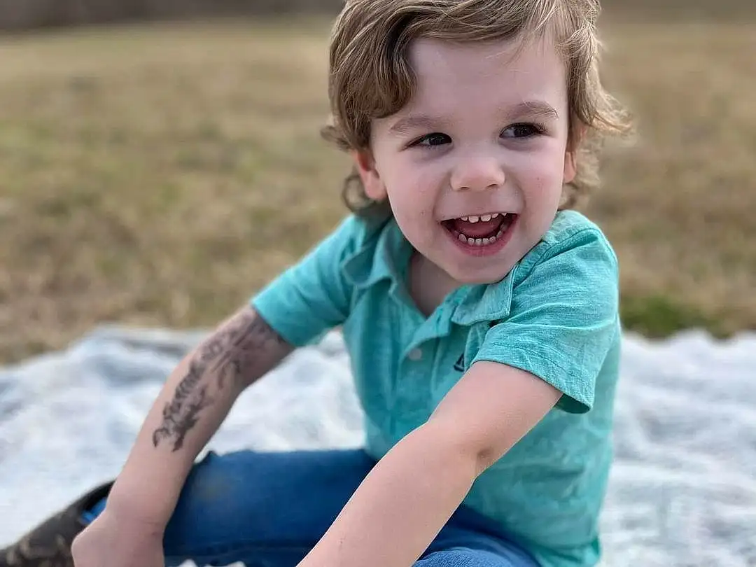 Smile, Skin, Facial Expression, People In Nature, Leg, Flash Photography, Sleeve, Happy, Grass, T-shirt, Toddler, Fun, Leisure, Denim, Tree, Child, Human Leg, Electric Blue, Blond, Person, Joy