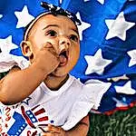 Blue, Happy, Sleeve, People In Nature, Gesture, Finger, Toddler, Baby & Toddler Clothing, Baby, Flag Of The United States, Thumb, Fun, T-shirt, Event, Child, Electric Blue, Flag Day (usa), Holiday, Pattern, Fictional Character, Person