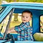 Vehicle, Yellow, Tartan, Leisure, Vroom Vroom, Fun, Toddler, Happy, Grass, Recreation, Baby & Toddler Clothing, Electric Blue, T-shirt, Plaid, Child, Travel, Sitting, Play, Automotive Design, Person