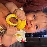 Nose, Cheek, Skin, Head, Lip, Hand, Mouth, Smile, Iris, Orange, Dress, Happy, Gesture, Finger, Baby & Toddler Clothing, Baby Grabbing For Something, Baby, Toddler, Thumb, Nail, Person