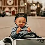 Face, Outerwear, Photograph, Vehicle, White, Hood, Vroom Vroom, Black, Tire, Automotive Design, Wheel, Flash Photography, Mode Of Transport, Baby, Toddler, Automotive Lighting, Happy, Travel, Jacket, Automotive Exterior, Person