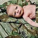 Skin, Camouflage, Military Camouflage, Eyes, Green, Textile, Gesture, Toddler, People In Nature, Child, Baby, Wood, Pattern, Military Uniform, Linens, Comfort, Happy, Soldier, Chest, Grass, Person