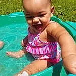 Smile, Skin, Water, Green, Happy, Fun, Leisure, Toddler, Baby & Toddler Clothing, Grass, Summer, Child, People, Recreation, Baby, Bathing, Play, Sitting, Thigh, Vacation, Person, Joy