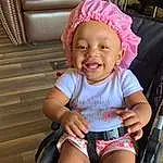 Face, Cheek, Skin, Smile, Baby & Toddler Clothing, Pink, Toddler, Comfort, Happy, Baby, Fun, Child, Baby Carriage, Magenta, Lap, Thigh, Baby Products, Wheel, Sitting, Shorts, Person, Joy, Headwear
