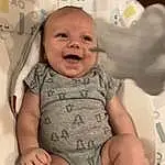 Face, Nose, Cheek, Skin, Head, Smile, Hand, Hairstyle, Arm, Eyes, Facial Expression, Mouth, White, Comfort, Sleeve, Baby & Toddler Clothing, Baby, Gesture, Happy, Person
