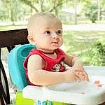Skin, Dress, Sleeve, Baby & Toddler Clothing, Happy, Plant, Baby, Grass, Toddler, Leisure, T-shirt, Bib, Sitting, Child, Fun, Recreation, People In Nature, Chair, Baby Products, Person