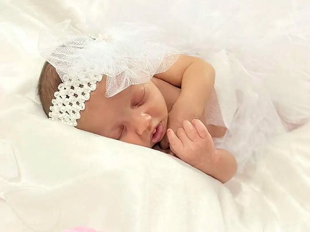 Hand, Arm, Comfort, Baby Sleeping, Textile, Baby, Happy, Pink, Headgear, Flash Photography, Baby & Toddler Clothing, Finger, Toddler, Linens, Headpiece, Petal, Child, Bedding, Hair Accessory, Bedtime, Person, Headwear
