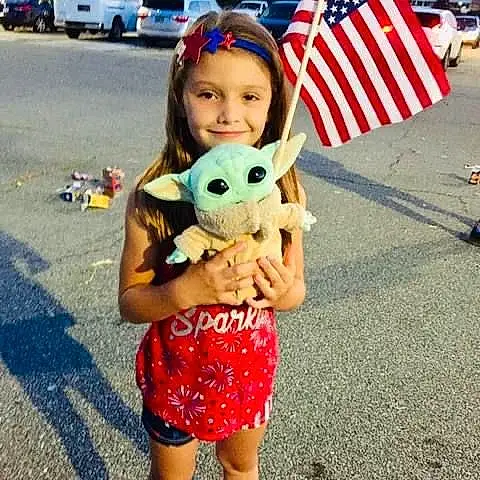 Head, Smile, Sleeve, Toy, Happy, Grass, Summer, Flag, Fun, Leisure, Stuffed Toy, T-shirt, Flag Of The United States, Event, Recreation, Shorts, Pattern, Vacation, Child, Plush, Person, Joy, Headwear