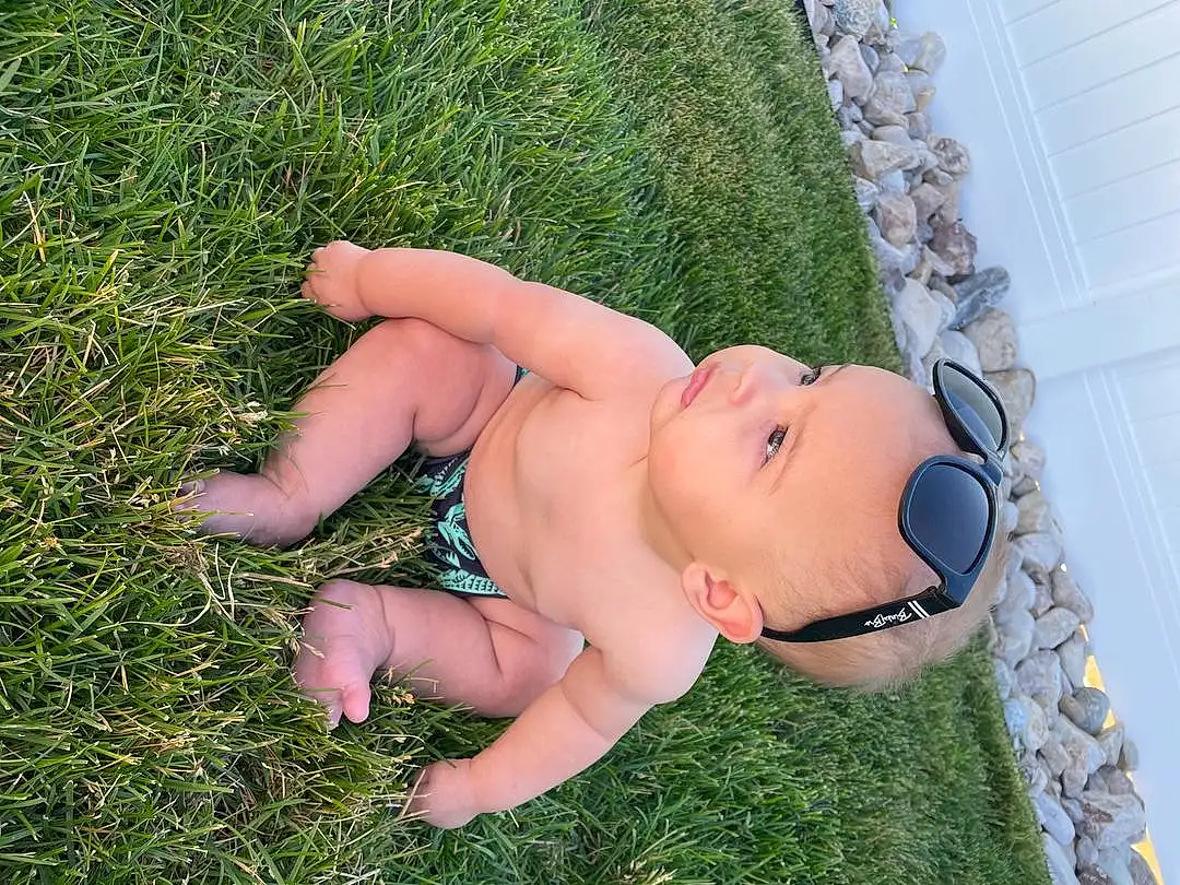 Eyes, Plant, People In Nature, Human Body, Thigh, Happy, Grass, Baby, Chest, Trunk, Meadow, Leisure, Human Leg, Lawn, Eyewear, Grassland, Abdomen, Thumb, Toddler, Foot, Person, Headwear