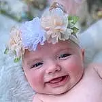 Face, Skin, Head, Smile, Lip, Eyes, Flower, Plant, Happy, Cap, Petal, Pink, Headgear, Baby, Costume Hat, Baby & Toddler Clothing, Toddler, Hat, Headpiece, Headband, Person, Joy, Headwear