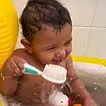 Nose, Water, Skin, Hand, Bathtub, Muscle, Human Body, Bathroom, Bathing, Yellow, Happy, Toddler, Leisure, Baby, Bath Toy, Chest, Fun, Child, Recreation, Balloon, Person