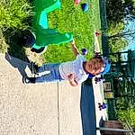 Plant, Leaf, Tree, Leisure, Happy, Grass, People In Nature, Fun, Recreation, Electric Blue, City, Sky, Toddler, Playground, Outdoor Play Equipment, Soil, Play, Child, Shadow, Person