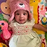 Clothing, Cheek, Skin, White, Baby & Toddler Clothing, Textile, Sleeve, Dress, Pink, Happy, Child, Toddler, Baby, Magenta, Cap, Beauty, Toy, Baby Products, Pattern, Costume Hat, Person, Headwear