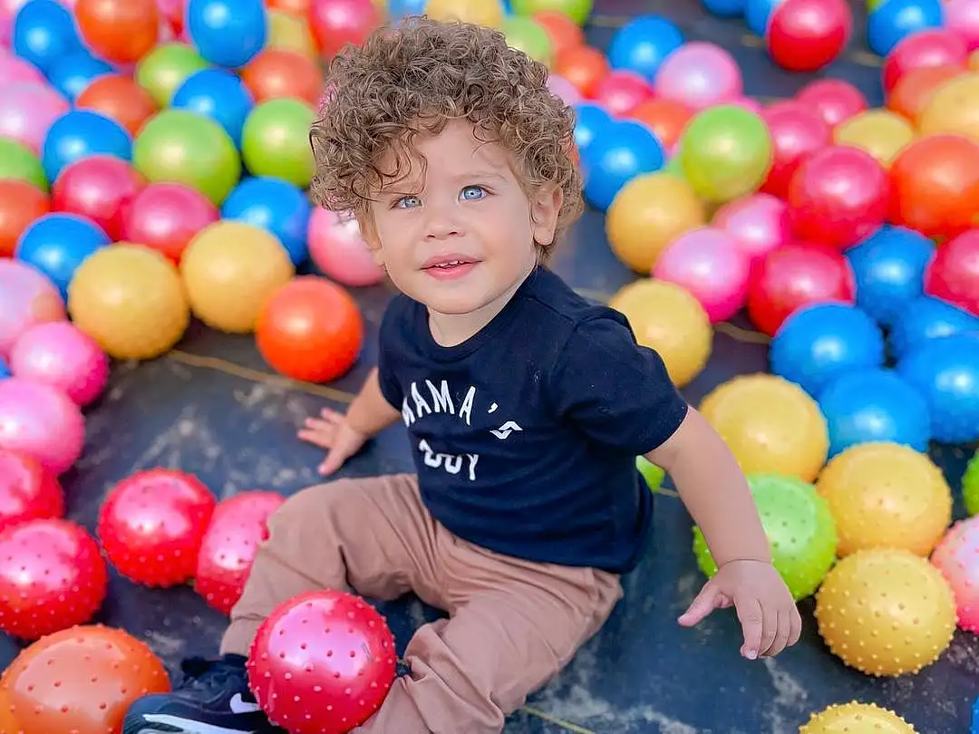 Ball Pit, Shirt, Photograph, Smile, Facial Expression, Playing Sports, White, Ball, Black, Happy, Yellow, Leisure, Fun, Public Space, T-shirt, Community, Recreation, Child, Toddler, Beauty, Person