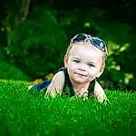 Smile, Eyes, Green, People In Nature, Flash Photography, Baby, Plant, Happy, Grass, Baby & Toddler Clothing, Natural Landscape, Terrestrial Plant, Toddler, Meadow, Grassland, Lawn, Electric Blue, Landscape, Prairie, Goggles, Person, Joy
