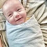 Cheek, Smile, Outerwear, Baby & Toddler Clothing, Comfort, Textile, Sleeve, Baby, Collar, Toddler, Happy, Linens, Child, Portrait Photography, Person