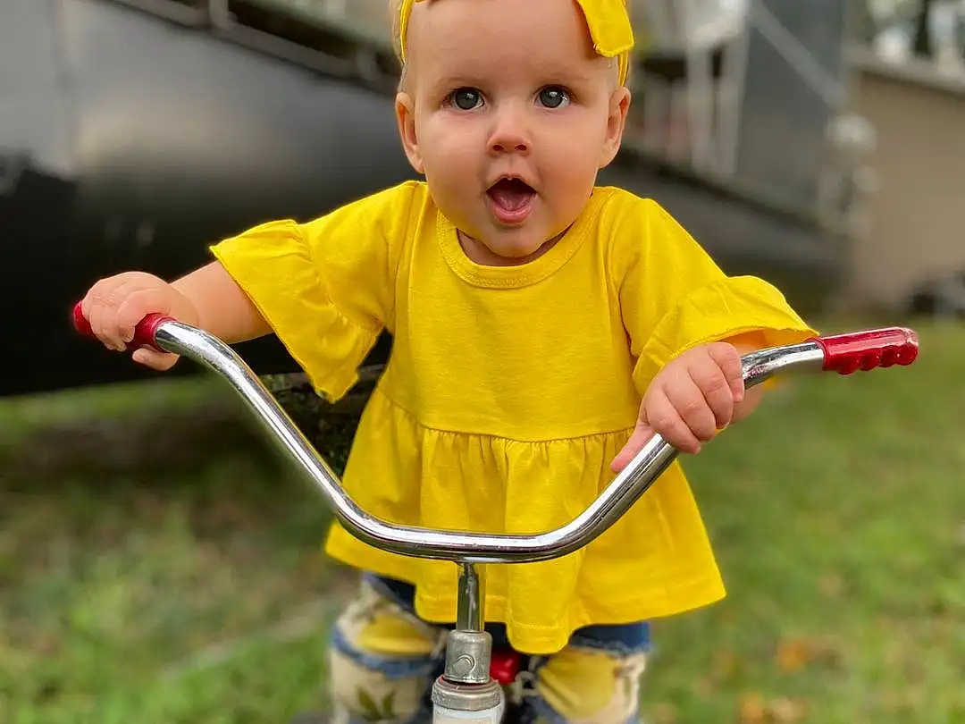 Bicycle, Wheel, Tire, Shorts, Bicycle Handlebar, Bicycle Frame, Bicycle Accessory, Bicycle Tire, Bicycle Wheel, Bicycles--equipment And Supplies, Yellow, Grass, Baby & Toddler Clothing, Bicycle Part, Baby, Toddler, Fun, Child, Riding Toy, Recreation, Person, Surprise