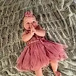 Dress, Baby & Toddler Clothing, Sleeve, One-piece Garment, Day Dress, Pink, Embellishment, Toddler, Ruffle, Magenta, Headpiece, Happy, Pattern, Blond, Grass, Peach, Fashion Accessory, Fashion Design, Bridal Accessory, Hair Accessory, Person