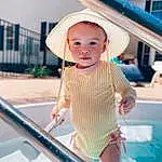 Skin, Blue, Dress, Pink, Leisure, Happy, Toddler, Fun, Hat, Summer, Recreation, Swimwear, Electric Blue, Baby, Swimming Pool, Child, Cap, Pattern, Vacation, Fashion Accessory, Person