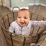 Face, Cheek, Skin, Smile, Eyes, Facial Expression, Wood, Baby & Toddler Clothing, Happy, Baby, Comfort, Toddler, Basket, Sleeve, Storage Basket, Child, Wicker, Sitting, Infant Bed, Person, Joy