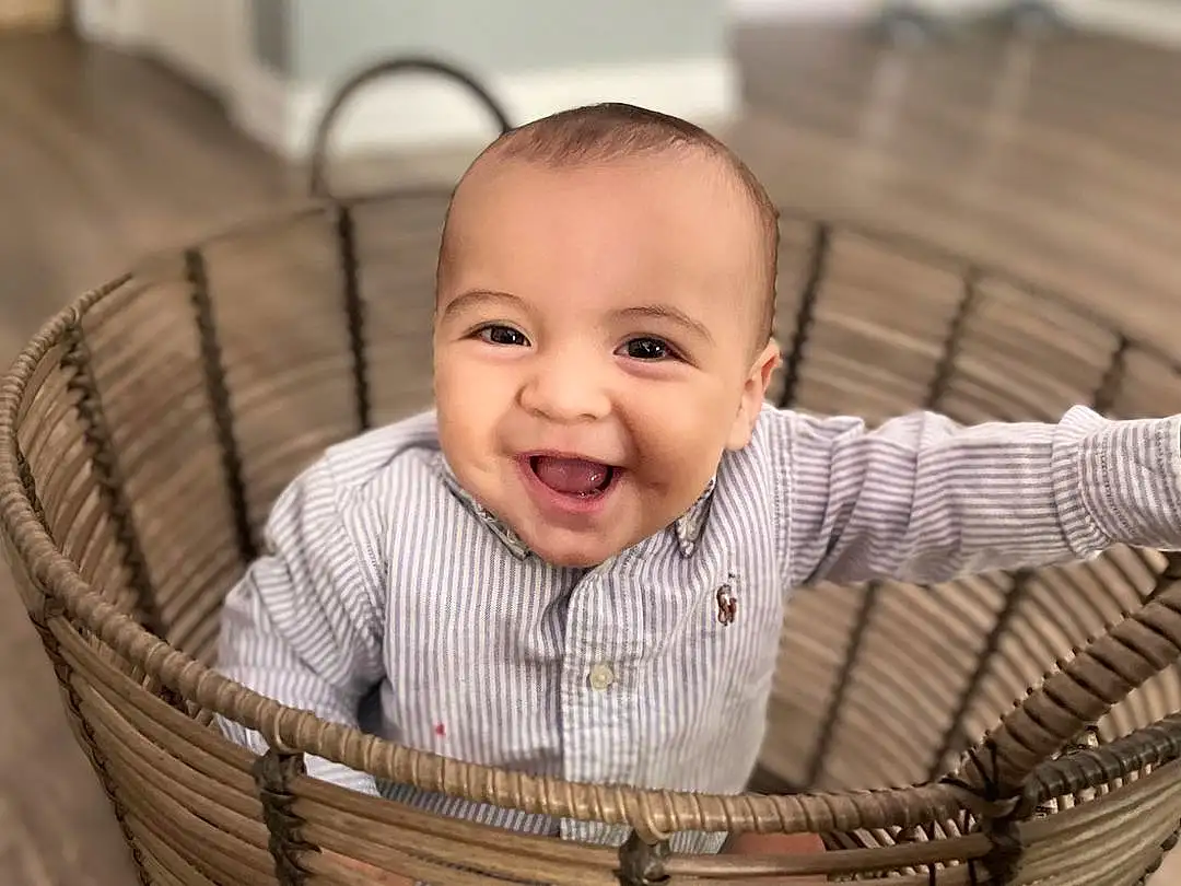 Face, Cheek, Skin, Smile, Eyes, Facial Expression, Wood, Baby & Toddler Clothing, Happy, Baby, Comfort, Toddler, Basket, Sleeve, Storage Basket, Child, Wicker, Sitting, Infant Bed, Person, Joy