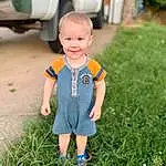 Smile, Plant, Wheel, Tire, Automotive Tire, Grass, People In Nature, Happy, Automotive Lighting, Baby & Toddler Clothing, Vroom Vroom, Automotive Exterior, Toddler, Fun, Child, Automotive Wheel System, Leisure, T-shirt, Lawn, Grassland, Person, Joy