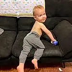 Comfort, Couch, Wood, Toddler, Living Room, Hardwood, Thigh, Baby, Baby & Toddler Clothing, Knee, Human Leg, Foot, Studio Couch, Sitting, Sock, Barefoot, Rectangle, Wood Flooring, Person