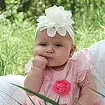 Skin, Head, Plant, Flower, Hand, Petal, Baby & Toddler Clothing, Smile, Happy, Baby, Grass, Pink, Headgear, Toddler, People In Nature, Tree, Headpiece, Headband, Flowering Plant, Nail, Person, Headwear