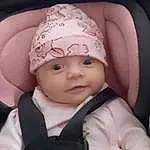 Face, Cheek, Skin, Head, Watch, Lip, Outerwear, Eyebrow, Eyes, Cap, Baby, Headgear, Baby & Toddler Clothing, Pink, Toddler, Flash Photography, Comfort, Happy, Child, Fashion Accessory, Person, Headwear
