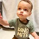 Face, Cheek, Joint, Skin, Hand, Shoulder, Baby & Toddler Clothing, Neck, Human Body, Sleeve, Standing, Gesture, Happy, Finger, T-shirt, Toddler, Baby, Thumb, Elbow, Person