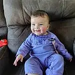 Cheek, Smile, Comfort, Purple, Baby & Toddler Clothing, Sleeve, Couch, Thigh, Toddler, Baby, Sock, Happy, T-shirt, Electric Blue, Knee, Sitting, Human Leg, Lap, Child, Chair, Person, Joy