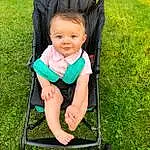 Wheel, Tire, Photograph, People In Nature, Plant, Baby Carriage, Grass, Toddler, Baby, Lawn, Fun, Child, Sitting, Baby Products, Smile, Baby & Toddler Clothing, Baby Safety, Leisure, Grassland, Person, Joy