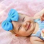 Face, Skin, Head, Hand, Smile, Eyes, Facial Expression, Comfort, Hat, Gesture, Baby & Toddler Clothing, Finger, Happy, Toddler, Baby, Baby Sleeping, Linens, Thumb, Pattern, Electric Blue, Person, Joy, Headwear
