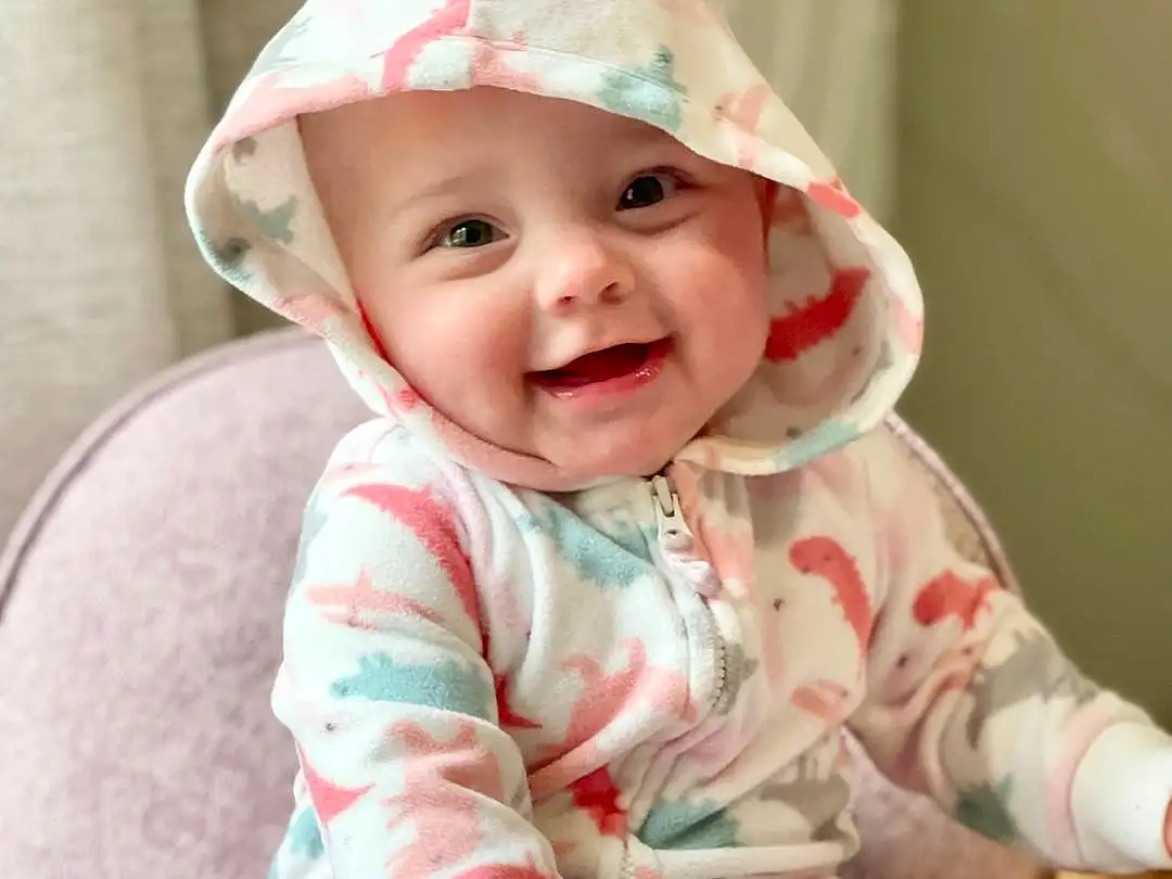 Smile, Cheek, Skin, Head, Eyes, Human Body, Baby & Toddler Clothing, Sleeve, Pink, Happy, Comfort, Baby, Party Hat, Toddler, Costume Hat, Cap, Child, Sitting, Fun, Fashion Accessory, Person, Joy, Headwear