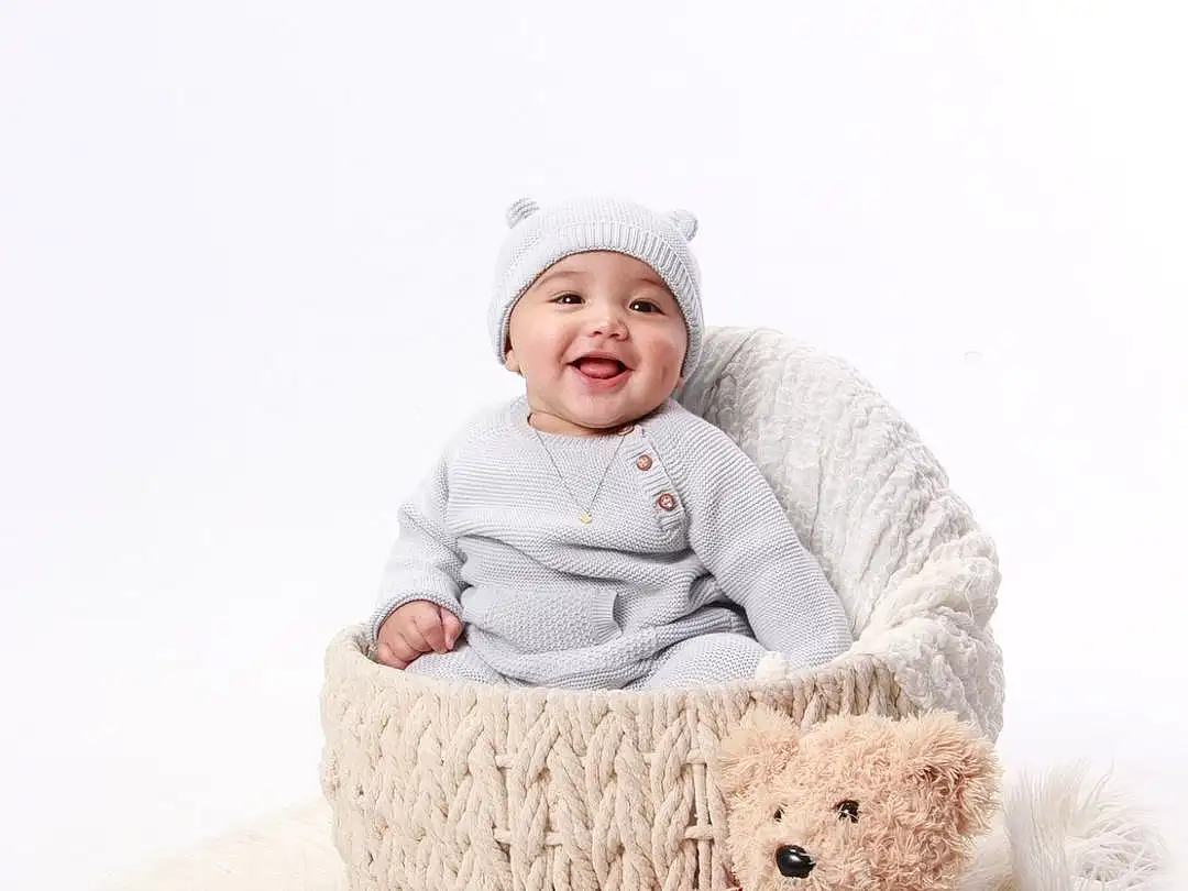 Face, Smile, Comfort, Sleeve, Toy, Baby & Toddler Clothing, Happy, Toddler, Teddy Bear, Child, Companion dog, Baby, Furry friends, Freezing, Stuffed Toy, Sitting, Winter, Baby Sleeping, Linens, Beanie, Person, Joy, Headwear