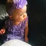 Skin, Baby & Toddler Clothing, Purple, Sleeve, Dress, Flash Photography, Iris, Pink, Violet, Toddler, Baby, Embellishment, Child, Happy, Headpiece, Magenta, Petal, Electric Blue, Fashion Accessory, Furry friends, Person