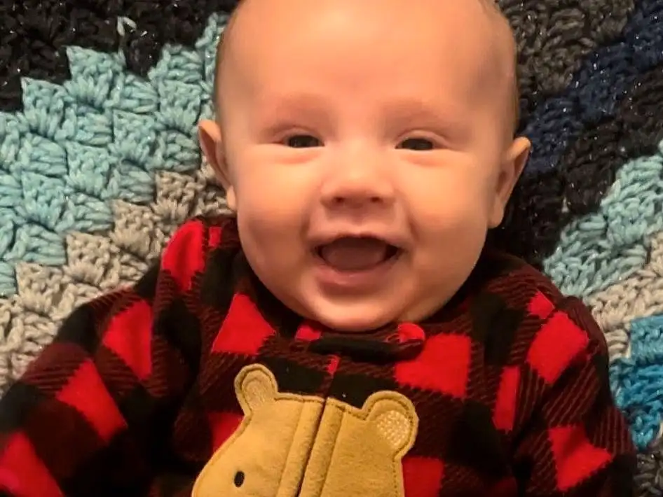 Face, Nose, Cheek, Skin, Chin, Outerwear, Smile, Eyes, Tartan, Dress, Sleeve, Baby & Toddler Clothing, Wood, Orange, Standing, Plaid, Plant, Happy, Red, Toddler, Person