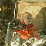 Baby Carriage, Baby, Musical Instrument, Soldier, Toddler, Baby Products, Personal Protective Equipment, Military Camouflage, Military Organization, Sitting, Infantry, Military, Helmet, Auto Part, Child, Uniform, Hat, Army, Glass, Person