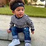 Clothing, Footwear, Outerwear, Shoe, Arm, Eyes, Leg, Smile, Sleeve, Standing, Baby & Toddler Clothing, Happy, Headgear, Cool, Toddler, Cap, Denim, Grass, Sneakers, Child, Person, Headwear