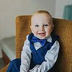 Face, Cheek, Smile, Head, Comfort, Baby & Toddler Clothing, Sleeve, Baby, Iris, Collar, Happy, Toddler, Electric Blue, Formal Wear, Couch, Child, Sitting, Tie, Flash Photography, Person, Joy