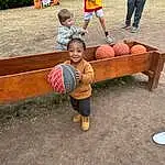 Shorts, Asphalt, Grass, Leisure, Bench, Public Space, Ball, Fun, Sneakers, People, Toddler, Wood, Recreation, Road Surface, Sidewalk, Sitting, Child, Soil, Competition Event, Person, Joy