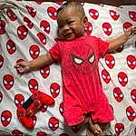 Smile, Shirt, Facial Expression, Baby & Toddler Clothing, Sleeve, Happy, Baby, T-shirt, Red, Toddler, Cool, Child, Pattern, Linens, Carmine, Comfort, Baby Toys, Play, Fictional Character, Pajamas, Person