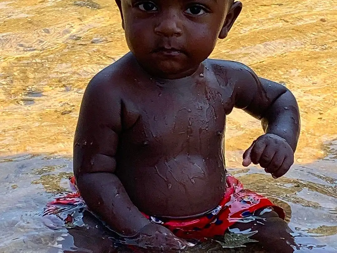 Nose, Cheek, Water, Eyes, Facial Expression, Human Body, Happy, People In Nature, Chest, Toddler, Bathing, Fun, Child, Smile, Leisure, People On Beach, Barechested, Baby, Play, Sitting