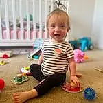 Clothing, Skin, Smile, Facial Expression, Baby Playing With Toys, Standing, Baby & Toddler Clothing, Happy, Toddler, Fun, Wood, People, Baby, Beauty, Leisure, Child, T-shirt, Sitting, Person