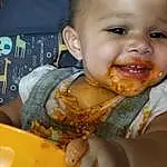 Nose, Cheek, Head, Food, Baby Playing With Food, Mouth, Orange, Food Craving, Tableware, Toddler, Cuisine, Biting, Baby & Toddler Clothing, Chair, Happy, Baby, Dish, Eating, Fun, Comfort Food, Person