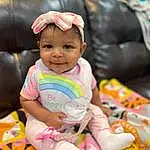 Cheek, Skin, Smile, Facial Expression, Happy, Pink, Baby, Baby & Toddler Clothing, Toddler, Baby Playing With Toys, Fun, Leisure, Comfort, Toy, Child, Sitting, Baby Products, Play, Stuffed Toy, Person, Joy, Headwear
